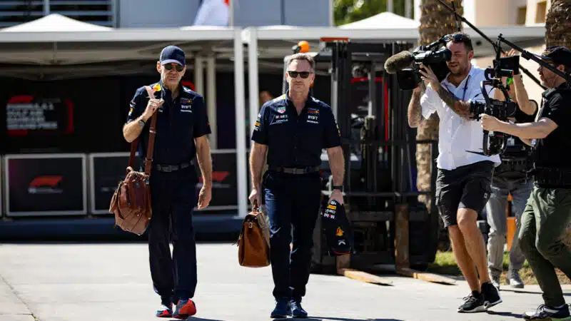 Cameras film Christian Horner and Adrian Newey in the F1 paddock in 2024