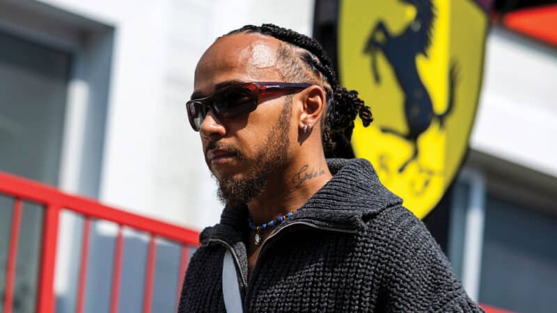 Lewis Hamilton in front of Ferrari sign