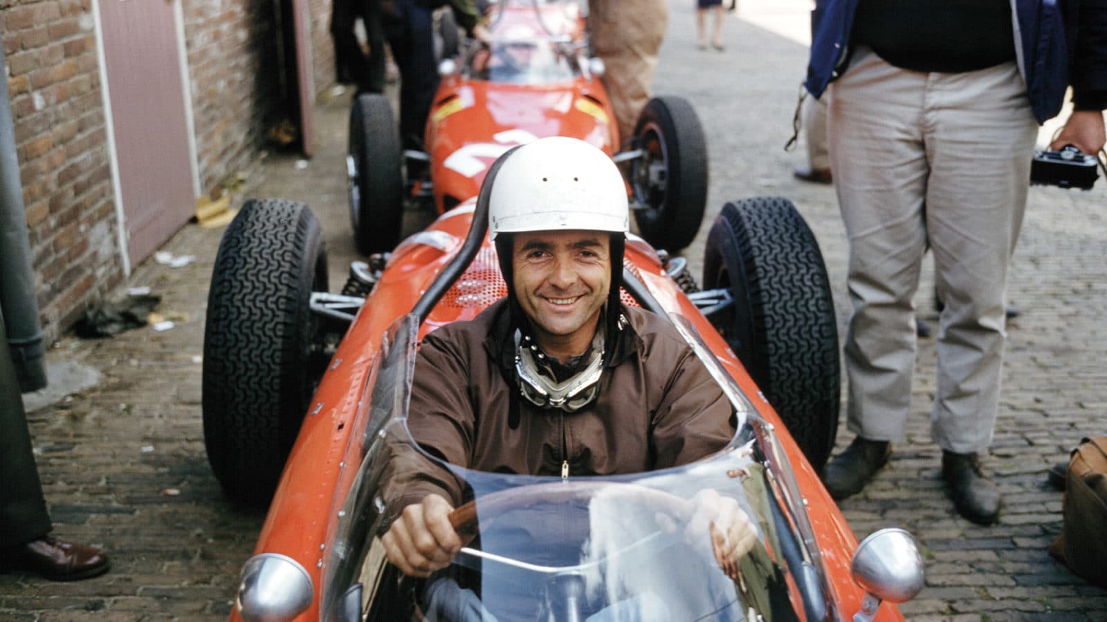 Phil Hill waits for practice at Zandvoort