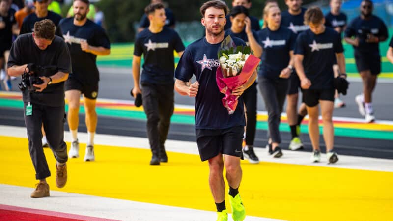 Pierre Gasly lays flowers for Anthoine Hubert at Spa ahead of the 2024 F1 Belgian Grand Prix